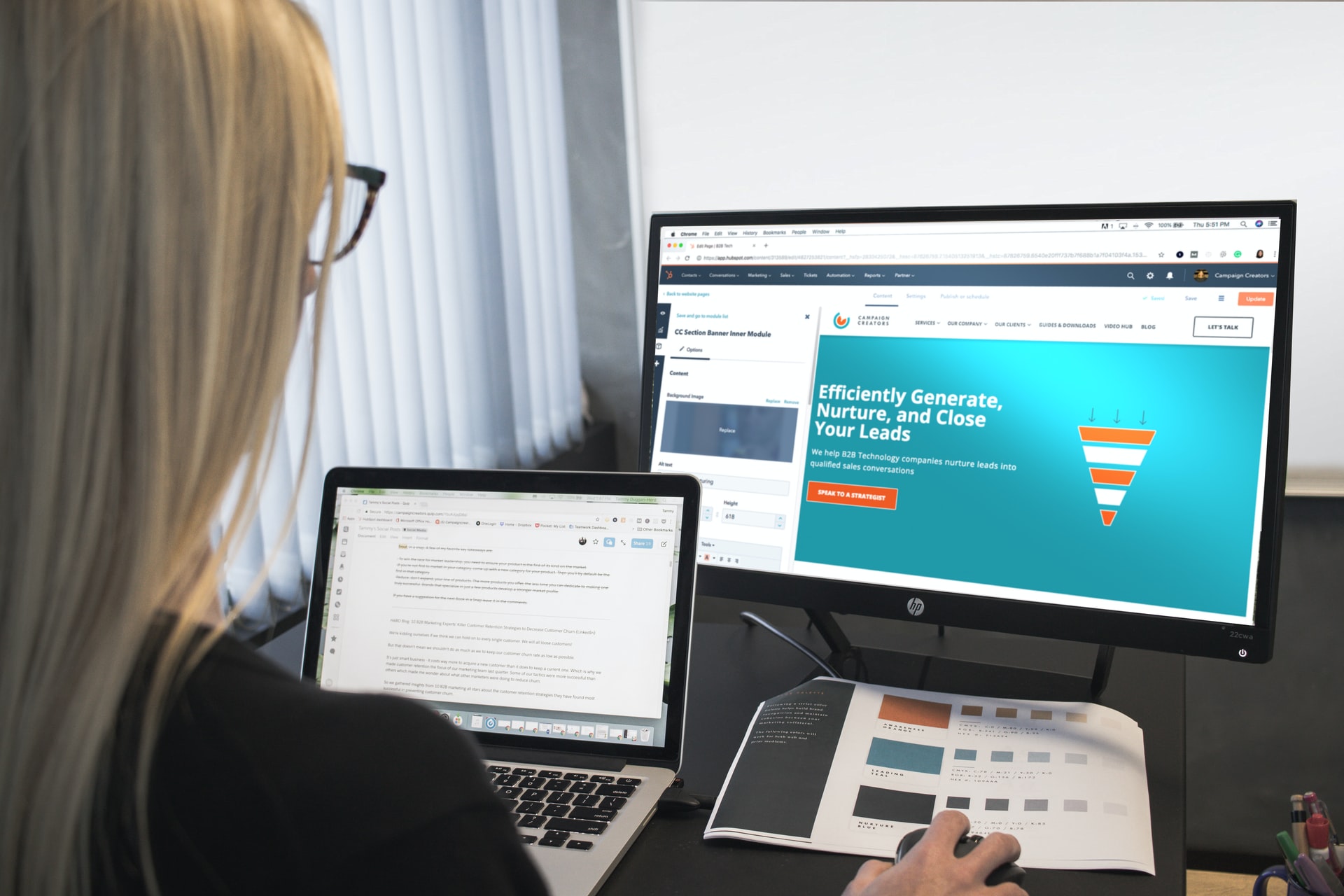 Woman working on two computers